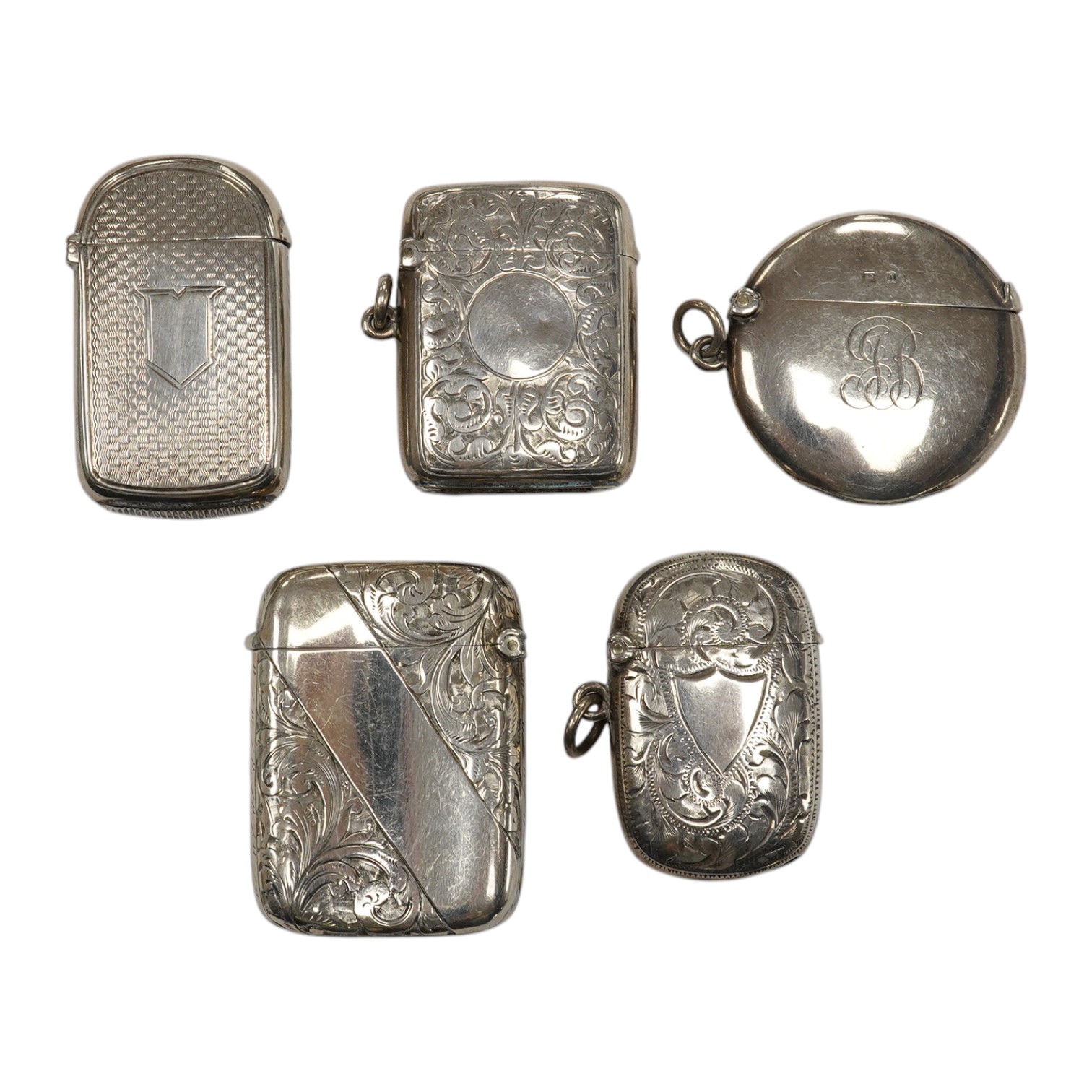 Five assorted late 19th/early 20th century silver vesta cases, including a George V circular case by William Neale Ltd, 45mm and a late Victorian arched by George Unite. Condition - fair